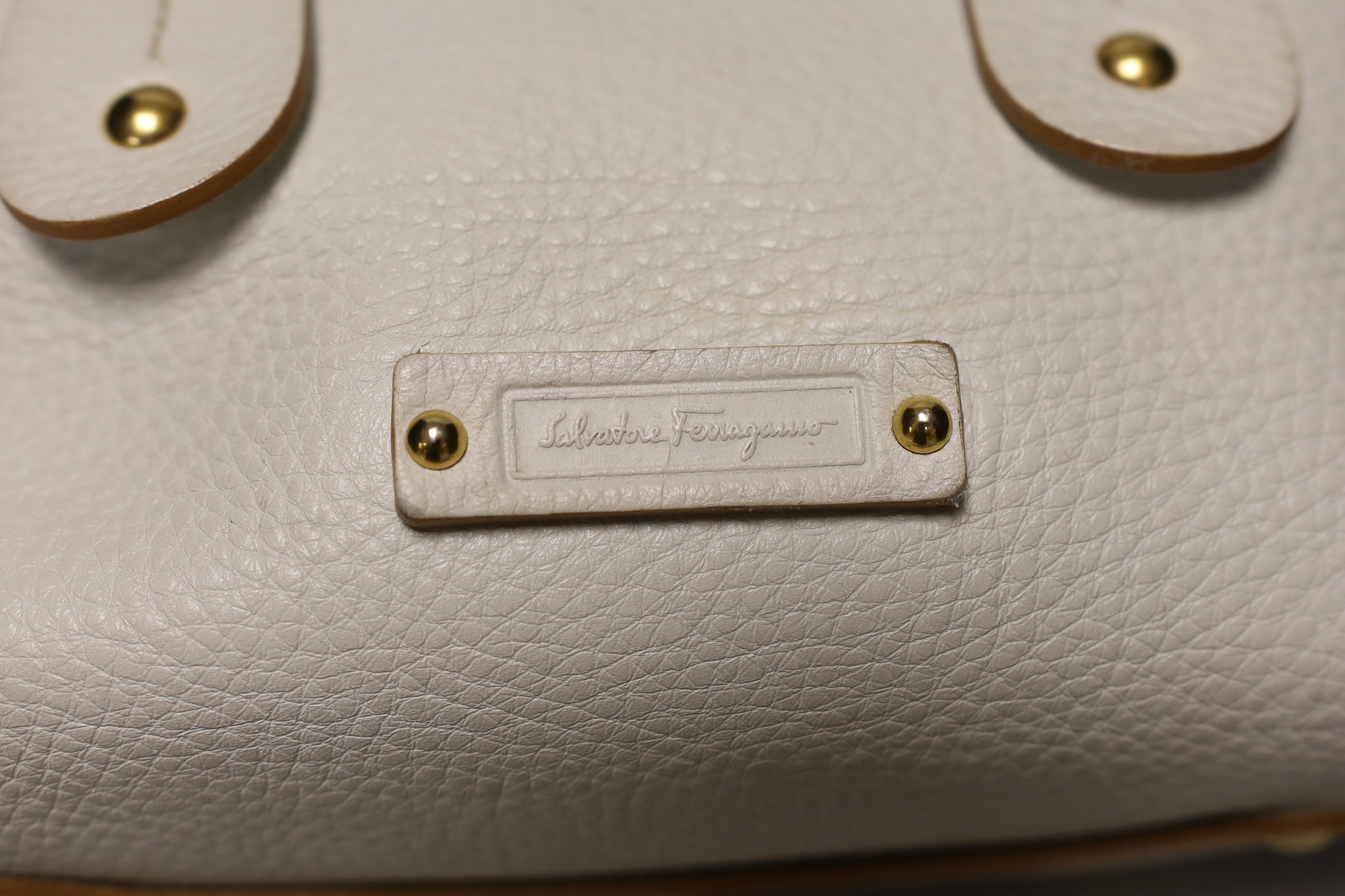 A buffalo tan leather Longchamp Women’s bag, together with a white leather Salvatore Ferragamo Women's shoulder bag. Both with original dust bags